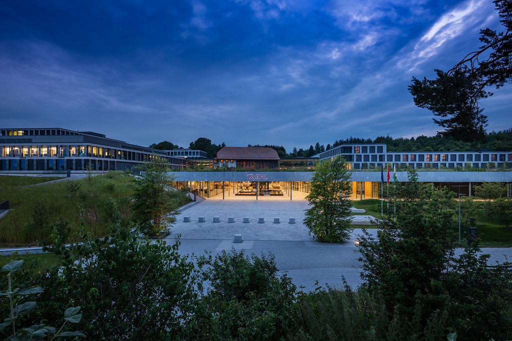 Luxury hotel exterior at dusk with warm golden lighting